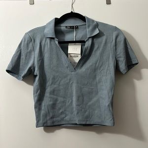 Blue collared tshirt. New with tags. Size large from Zara